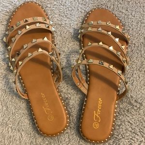 Gold studded tan sandals.